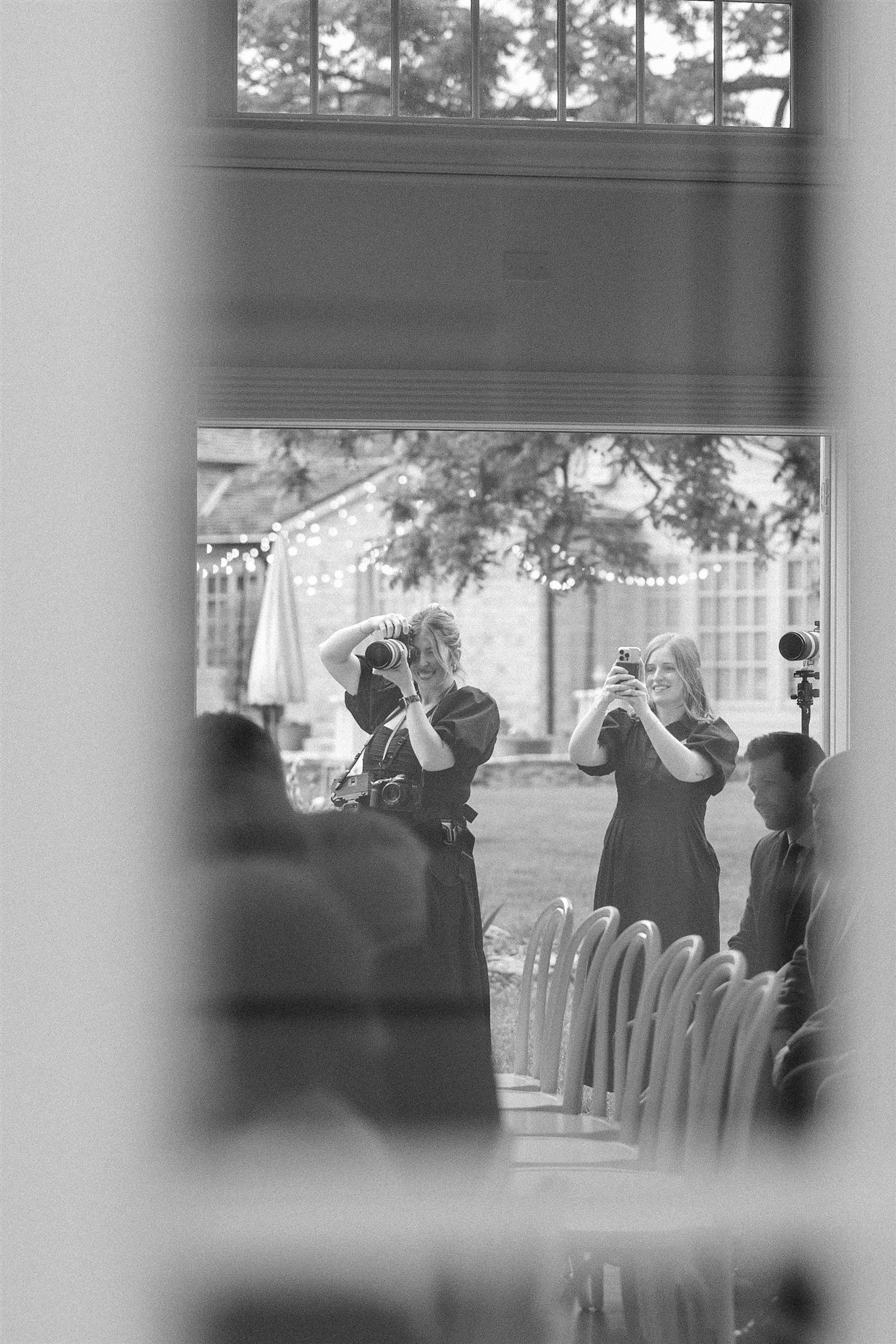 Photo of photographer and wedding content creator in black and white